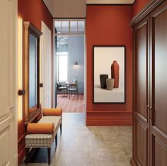 a hallway with red walls and wooden doors