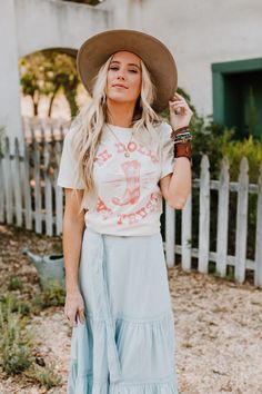 In Dolly We Trust Tee is every country western girl's motto! Pink graphic on an ivory tee make it easy to match with maxi skirts and jeans! *Due to lighting and differences in monitors, actual colors may vary slightly from what appears online. Model is 5'8" and wearing a size Small. Approximate measurements are as follows: SMALL: Bust: 33", Length: 27", Sleeve length: 7.5 " MEDIUM: Bust: 35", Length: 27.5", Sleeve length: 7.5 " LARGE: Bust: 37", Length: 28", Sleeve length: 7.5 " 100% Cotton Mach Spring Graphic Tee For Rodeo, Spring Rodeo Graphic Tee, Graphic Tee For Rodeo And Spring, White T-shirt For Summer Rodeo, Summer Graphic Print Tops For Country Events, Graphic Print Tops For Summer Country Events, Graphic Print Tops For Country Events In Summer, Short Sleeve Tops For Rodeo In Spring, Short Sleeve Tops For Spring Rodeo