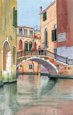 a watercolor painting of a bridge over a canal with buildings and people on it