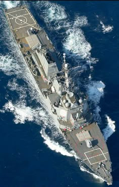 an aerial view of a navy ship in the ocean