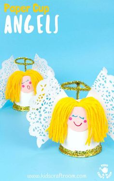 two paper cup angels with blonde hair and angel wings on them, sitting next to each other