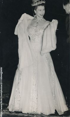 an old black and white photo of a woman in a gown with a tiara