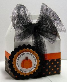 an orange and white gift box with a black bow on the top that says what way to the pumpkin?