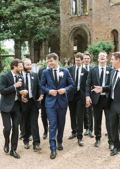 a group of men in suits standing next to each other