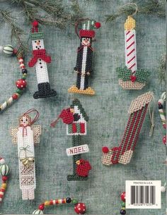 cross stitch christmas ornaments are displayed on the cover of a knitting book, which features an image of snowmen and candy canes