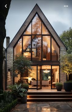 a house with large windows and stairs leading up to it