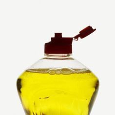 a yellow liquid bottle with a red cap