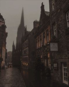 an old city street with tall buildings on both sides