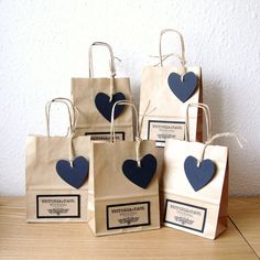 four bags with blue hearts on them sitting on a table