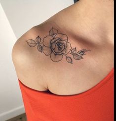 a woman with a rose tattoo on her shoulder