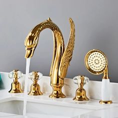 golden faucet with water running from it's side and three other faucets