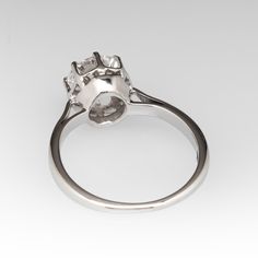 This classic vintage 1950s solitaire ring is crafted of 18k white gold and now holds a 1.01ct lab grown diamond that is IGI certified and grades E in color and VVS2 in clarity. The ring is currently a size 4. EraGem lab diamond rings will arrive with an in-store certification as well as the IGI report and a lovely EraGem logo presentation box. Platinum Diamond Ring With Prong Setting, Classic Diamond White Cluster Ring For Proposal, Anniversary Platinum Cluster Ring With Center Stone, Classic Cluster Ring With Halo Setting For Proposal, Timeless Platinum Diamond Ring For Proposal, Classic Platinum Cluster Ring With Vvs Clarity, Asscher Cut Brilliant Cluster Ring For Anniversary, Platinum Halo Ring With Diamond Cut For Anniversary, Classic White Platinum Cluster Ring