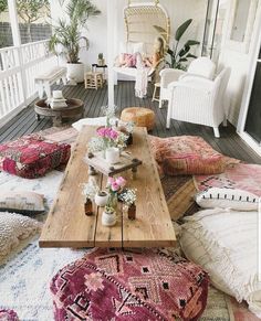 a living room filled with lots of furniture and pillows