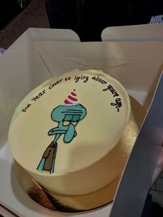 a birthday cake with an image of a cartoon character on the frosting is in a box