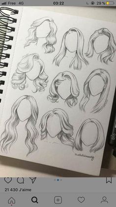 an open notebook with drawings of different hair styles