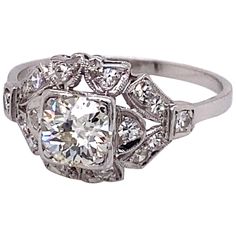 Vintage European Cut Diamond in Platinum Art Deco Ring - the center European cut diamond weighs .77ct with the quality of K color and VS2 clarity. The diamond sits low in a very detailed Art Deco platinum mounting with 16 single cut accent diamonds with fine milgrain workmanship. The side diamonds have a total approximate weight of .33ct. The ring is a size US 8 and can be sized. The ring is stamped 10% Irid. Plat. Art Deco Platinum Diamond Ring With Brilliant Cut, Gia Certified Diamond Ring In Fine Jewelry Style, Gia Certified Asscher Cut Diamond White Diamond Ring, Art Deco Platinum Diamond Ring With Vvs Clarity, Heirloom Asscher Cut Gia Certified Diamond Ring, Art Deco Platinum Diamond Ring In Diamond White, Gia Certified Art Deco Diamond White Rings, Gia Certified Diamond White Art Deco Rings, Diamond Cluster Ring With Asscher Cut Brilliant