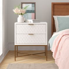 a bedroom scene with focus on the bed and nightstand, which is decorated in pastel colors