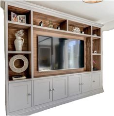 an entertainment center with built - in cabinets and a flat screen tv on the wall