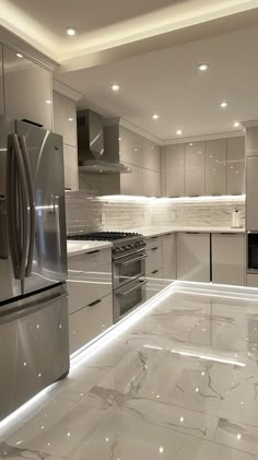 a kitchen with marble counter tops and stainless steel appliances