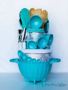 a stack of kitchen utensils in a blue bowl