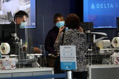 two people wearing masks in front of medical equipment