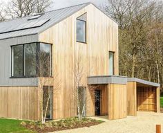 a large wooden house with two garages