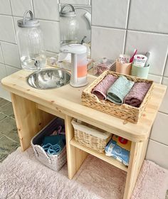 a wooden table with baskets and towels on it