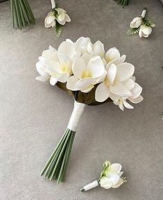 a bouquet of white flowers laying on the ground