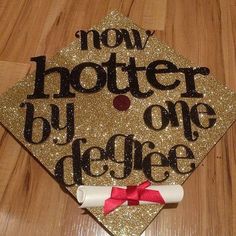 a graduation cap with the words, new hotter by college on it and a red bow