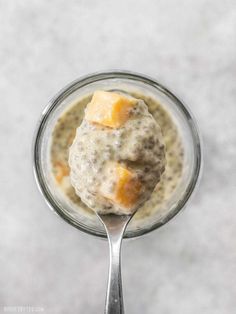 a spoon with some food in it on top of a table