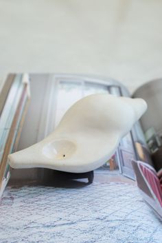 a white bird shaped object on top of a magazine