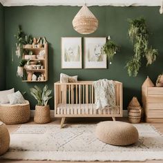 a baby's room with green walls and plants on the wall, including a crib