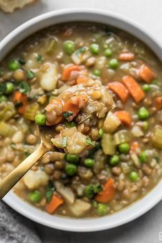 a white bowl filled with peas and carrots