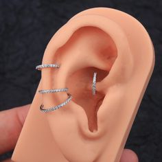 a fake ear is being held up to show the inside of it's ear