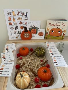 a tray filled with pumpkins and seeds on top of a table