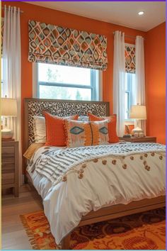 a bedroom with orange walls, white bedding and decorative window valances on the windowsill