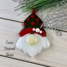 a glass ornament with a red and green hat on it's head