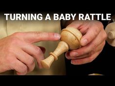 two hands holding a wooden toy with the words turning a baby rattle in front of them