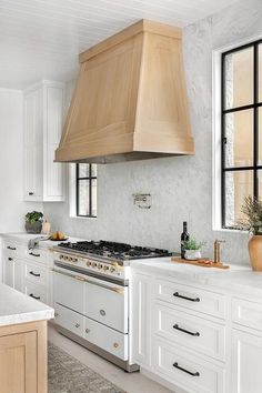 a kitchen with an oven, stove and counter tops in white painted wood paneling