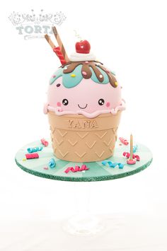 a cake shaped like an ice cream cone with a cherry on top