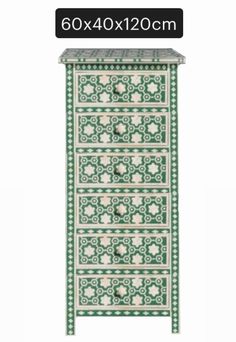 a green and white cabinet with four drawers on each side, one drawer has an intricate design