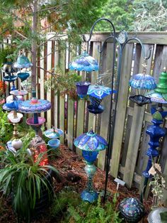 an outdoor garden with lots of colorful glass vases