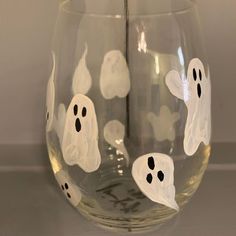 a wine glass decorated with ghost faces