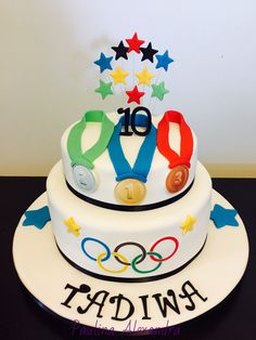 a white cake with the olympic symbols on it