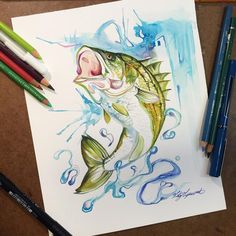 a drawing of a fish on paper with colored pencils