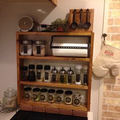 a shelf with spices and kitchen utensils on it