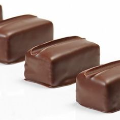 three pieces of chocolate sitting next to each other