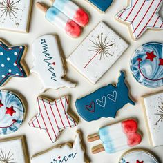 decorated cookies are arranged on a white surface