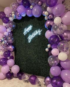 purple and white balloons are arranged around a square frame with the words happy birthday written on it