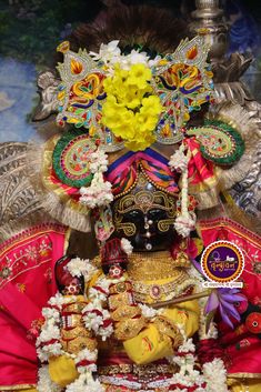 the statue is decorated with flowers and decorations